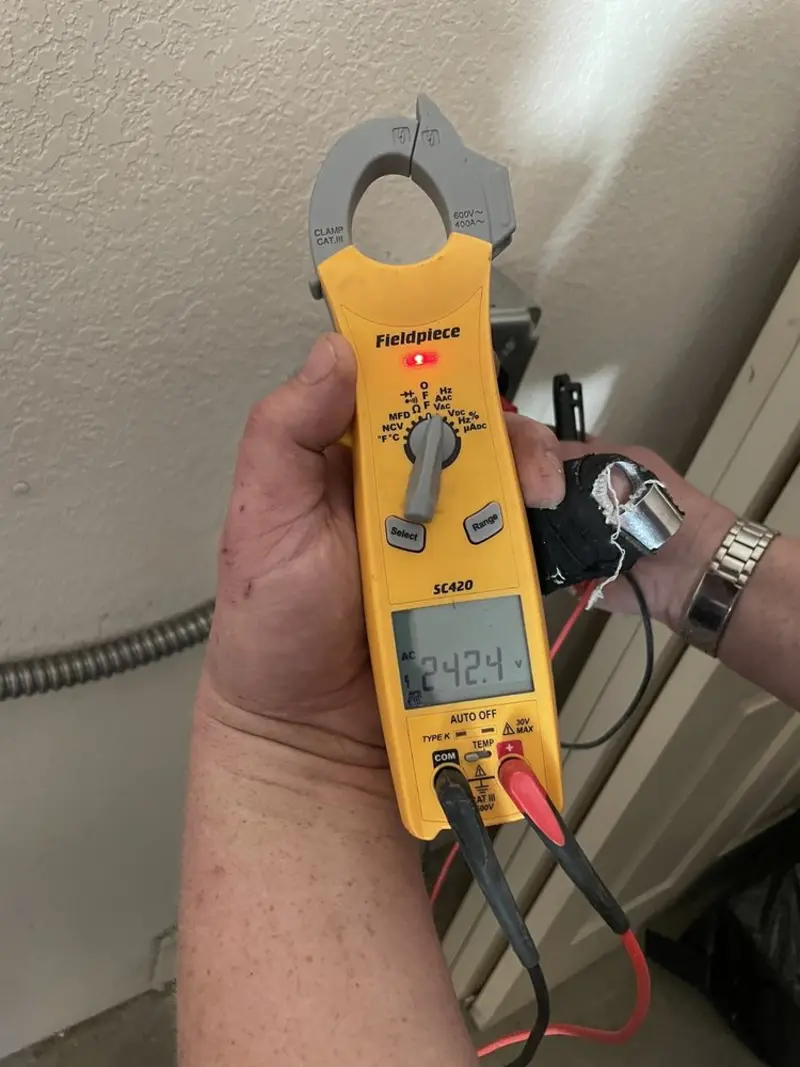 Voltage testing with clamp meter during Outlet Installation in Binghamton